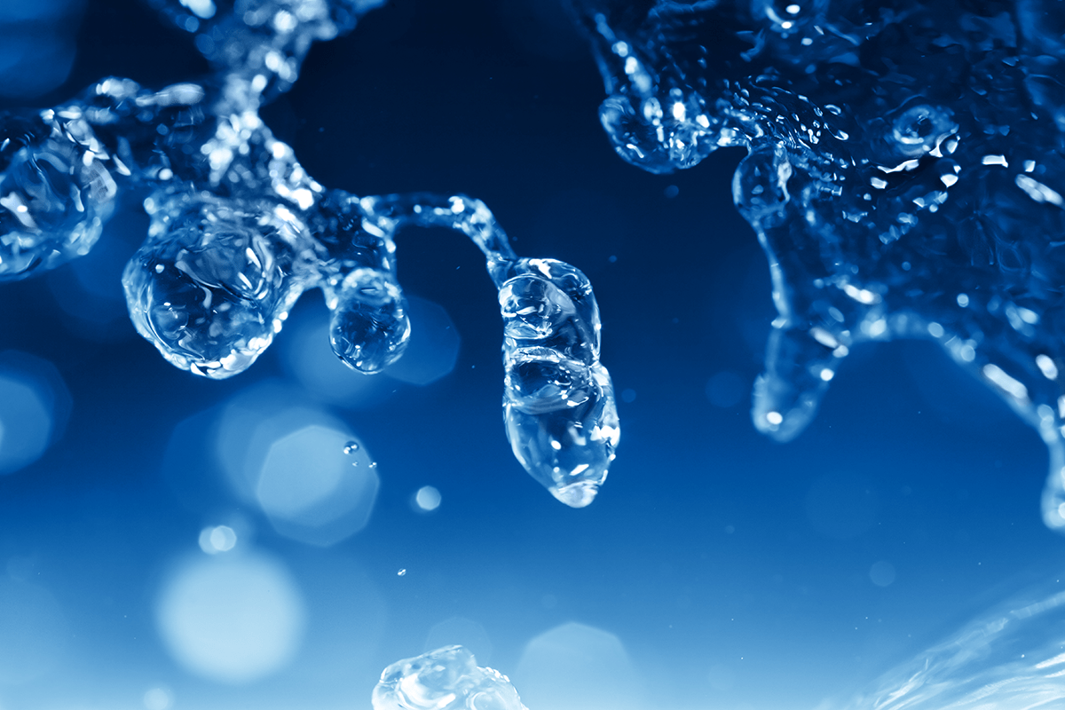 Close-up of water spray in front of abstract background