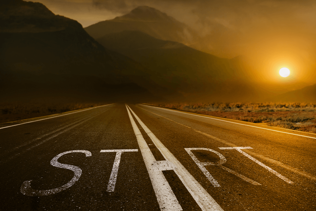 Road with 'Start' sign at sunset