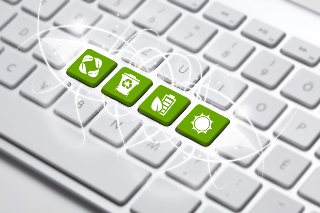White keyboard with four green keys in the middle, featuring symbols of recycling concept
